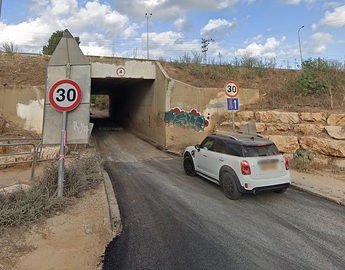 narrow pass under a bridge